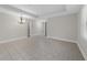 Open living area featuring tile flooring and a modern chandelier at 5280 Oak Hill Ter, Cumming, GA 30040