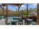 Outdoor community space featuring tables and chairs with a view of the pool and play area at 5280 Oak Hill Ter, Cumming, GA 30040