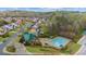 Aerial view of community pool, clubhouse, and surrounding neighborhood at 5280 Oak Hill Ter, Cumming, GA 30040