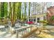 Enjoy this private deck with a table for 6, a lounge set, and a tree growing up through the deck at 730 Ponderosa Ct, Fayetteville, GA 30214