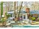 Home backyard with a wooden deck, patio furniture, and lush greenery at 730 Ponderosa Ct, Fayetteville, GA 30214