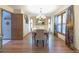 Bright dining room featuring wood floors, modern chandelier, and adjacent living area view at 730 Ponderosa Ct, Fayetteville, GA 30214
