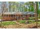 Charming brick ranch home with a welcoming front porch and mature trees in a well-maintained yard at 730 Ponderosa Ct, Fayetteville, GA 30214
