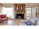 Cozy brick fireplace with decorative mantel in a living room with large windows and comfortable seating at 730 Ponderosa Ct, Fayetteville, GA 30214