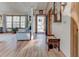 Bright foyer featuring wood floors, a wooden bench, and views into the living room with large windows at 730 Ponderosa Ct, Fayetteville, GA 30214