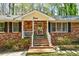 Inviting front porch with brick steps, white railings, and cheerful 'Love' sign above the entrance at 730 Ponderosa Ct, Fayetteville, GA 30214