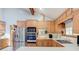 Modern kitchen design boasts stainless steel appliances, and white countertops with wood cabinetry at 730 Ponderosa Ct, Fayetteville, GA 30214