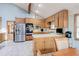 Open kitchen featuring stainless steel appliances, light countertops, and eat-in dining at 730 Ponderosa Ct, Fayetteville, GA 30214