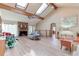 Open living room with skylights, brick fireplace, and wood floors, creating a bright and inviting space at 730 Ponderosa Ct, Fayetteville, GA 30214
