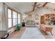 Open concept living room with vaulted ceilings, wood beams, and large windows with natural light at 730 Ponderosa Ct, Fayetteville, GA 30214