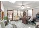 Bright sunroom with many windows, tile floors, desk, chair, and vintage furnishings at 730 Ponderosa Ct, Fayetteville, GA 30214
