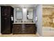 Bathroom featuring double sink vanity with granite countertops and a shower-tub combination at 105 Jefferson Cir, Sandy Springs, GA 30328