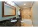 Bathroom with granite countertop vanity and a shower-tub combination with tile surround at 105 Jefferson Cir, Sandy Springs, GA 30328