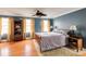 Comfortable bedroom featuring hardwood floors, ceiling fan, and natural light from multiple windows at 105 Jefferson Cir, Sandy Springs, GA 30328