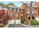Charming brick townhouse featuring a two-car garage and manicured landscaping at 105 Jefferson Cir, Sandy Springs, GA 30328