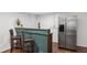 Basement wet bar featuring a stainless steel refrigerator, cabinetry, and two bar stools at 1254 Moores Mill Nw Rd, Atlanta, GA 30327