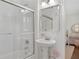 A bathroom with pedestal sink, mirrored cabinet, and shower-tub combo at 1254 Moores Mill Nw Rd, Atlanta, GA 30327