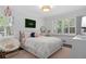 Bright bedroom featuring plantation shutters, white walls, and a cozy chair at 1254 Moores Mill Nw Rd, Atlanta, GA 30327