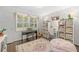 Comfortable room featuring a piano, shelving units, and a large window at 1254 Moores Mill Nw Rd, Atlanta, GA 30327