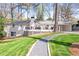 Well-maintained home exterior with a deck, lush lawn, and inviting landscaping at 1254 Moores Mill Nw Rd, Atlanta, GA 30327
