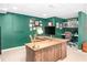 Home office showcasing wood desk, green walls, and custom built-in shelves at 1254 Moores Mill Nw Rd, Atlanta, GA 30327