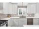 Bright kitchen with stainless steel appliances, gray backsplash, and white shaker cabinetry at 1254 Moores Mill Nw Rd, Atlanta, GA 30327