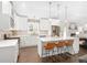 Modern kitchen with white cabinets, stainless steel appliances, quartz countertops, and an island with seating at 1254 Moores Mill Nw Rd, Atlanta, GA 30327