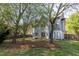 A beautiful backyard featuring mature trees, a storage shed, and a well-maintained lawn at 1855 Keswick Place Dr, Lawrenceville, GA 30043