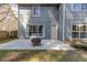 Backyard view with fire pit, patio, and grey siding at 1855 Keswick Place Dr, Lawrenceville, GA 30043
