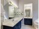 Bathroom featuring double sinks, vanity and well-lit mirror at 1855 Keswick Place Dr, Lawrenceville, GA 30043