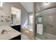 Bright bathroom with double sinks, glass shower, and tub at 1855 Keswick Place Dr, Lawrenceville, GA 30043