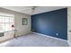 Bedroom with a window and a navy blue accent wall at 1855 Keswick Place Dr, Lawrenceville, GA 30043