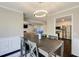 The dining room is decorated with wainscotting and a modern light fixture at 1855 Keswick Place Dr, Lawrenceville, GA 30043
