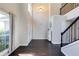 Spacious foyer with dark wood floors, staircase with black railings, and a view of the entryway at 1855 Keswick Place Dr, Lawrenceville, GA 30043