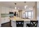 Bright kitchen featuring stainless steel appliances, granite countertops, and white cabinetry at 1855 Keswick Place Dr, Lawrenceville, GA 30043