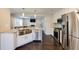 Modern kitchen featuring stainless steel appliances, light cabinets, and breakfast bar at 1855 Keswick Place Dr, Lawrenceville, GA 30043