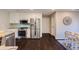 Bright kitchen with stainless steel appliances, dark wood floors, and a view to the breakfast area at 1855 Keswick Place Dr, Lawrenceville, GA 30043