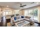 Comfortable living room featuring a large sectional sofa, stylish rug, and bright natural light at 1855 Keswick Place Dr, Lawrenceville, GA 30043