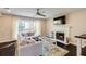 The large windows brighten the living room which has a tv, fireplace, and sectional sofa at 1855 Keswick Place Dr, Lawrenceville, GA 30043