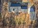 This aerial view captures the layout of the home, its deck, detached garage, and the property's mature trees at 35 Tracechain, Stockbridge, GA 30281