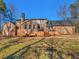 Expansive backyard featuring a brick home with a wooden deck and ample greenery, perfect for outdoor enjoyment at 35 Tracechain, Stockbridge, GA 30281