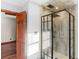 Bathroom featuring a tiled shower and an open doorway with wood trim at 35 Tracechain, Stockbridge, GA 30281