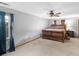 Spacious bedroom featuring neutral walls, a ceiling fan, and a large sleigh bed with matching nightstand at 35 Tracechain, Stockbridge, GA 30281