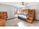 Bedroom features a wooden bunk bed, a wooden bookshelf, carpet flooring, and a ceiling fan at 35 Tracechain, Stockbridge, GA 30281