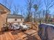 Relaxing outdoor deck space features comfortable seating, a fire pit, and a wooded view at 35 Tracechain, Stockbridge, GA 30281