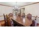 Formal dining room featuring an ornate chandelier, detailed trim, and hardwood flooring at 35 Tracechain, Stockbridge, GA 30281