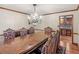 Dining room with an ornate table and chairs, a hanging chandelier, and hardwood flooring at 35 Tracechain, Stockbridge, GA 30281