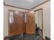 Entryway showcasing black tile floors, wooden doors, and a view of a guest bathroom at 35 Tracechain, Stockbridge, GA 30281