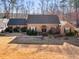 Attractive single-story brick home boasts a manicured lawn, mature trees, and a welcoming front entrance at 35 Tracechain, Stockbridge, GA 30281