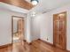 Hallway with hardwood floors, white walls, and natural wood trim around the door frames at 35 Tracechain, Stockbridge, GA 30281
